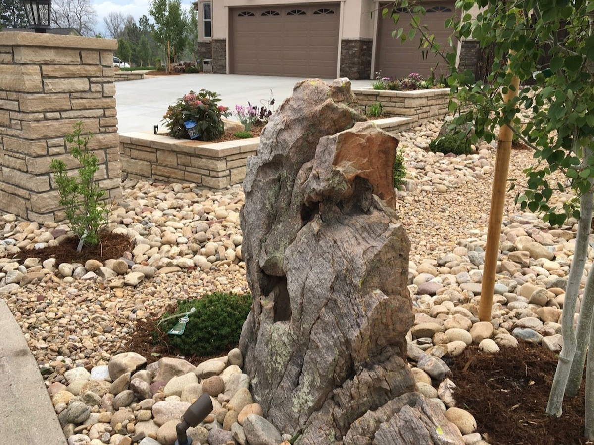 A feature boulder set into a gravel bed