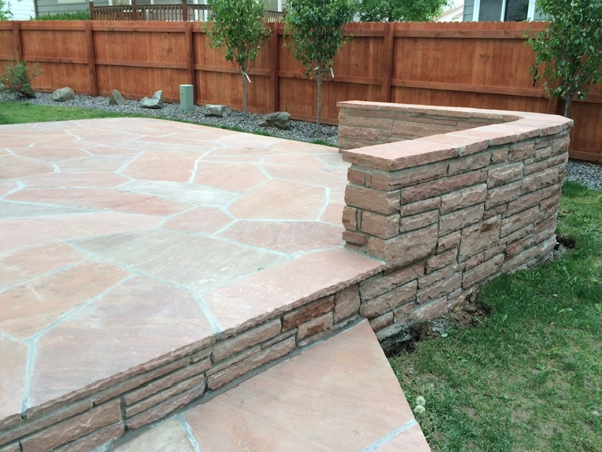 Flagstone patio with a raised seat wall