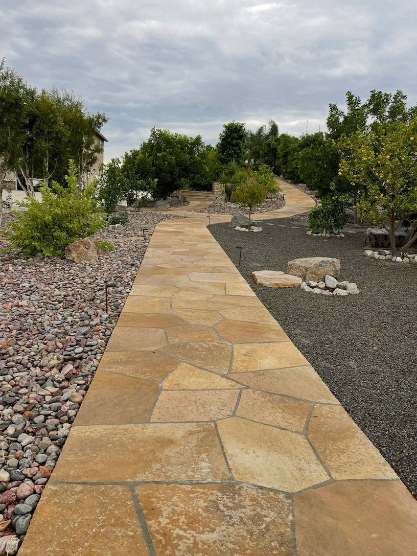 Flagstone walkway through a gravel front yard